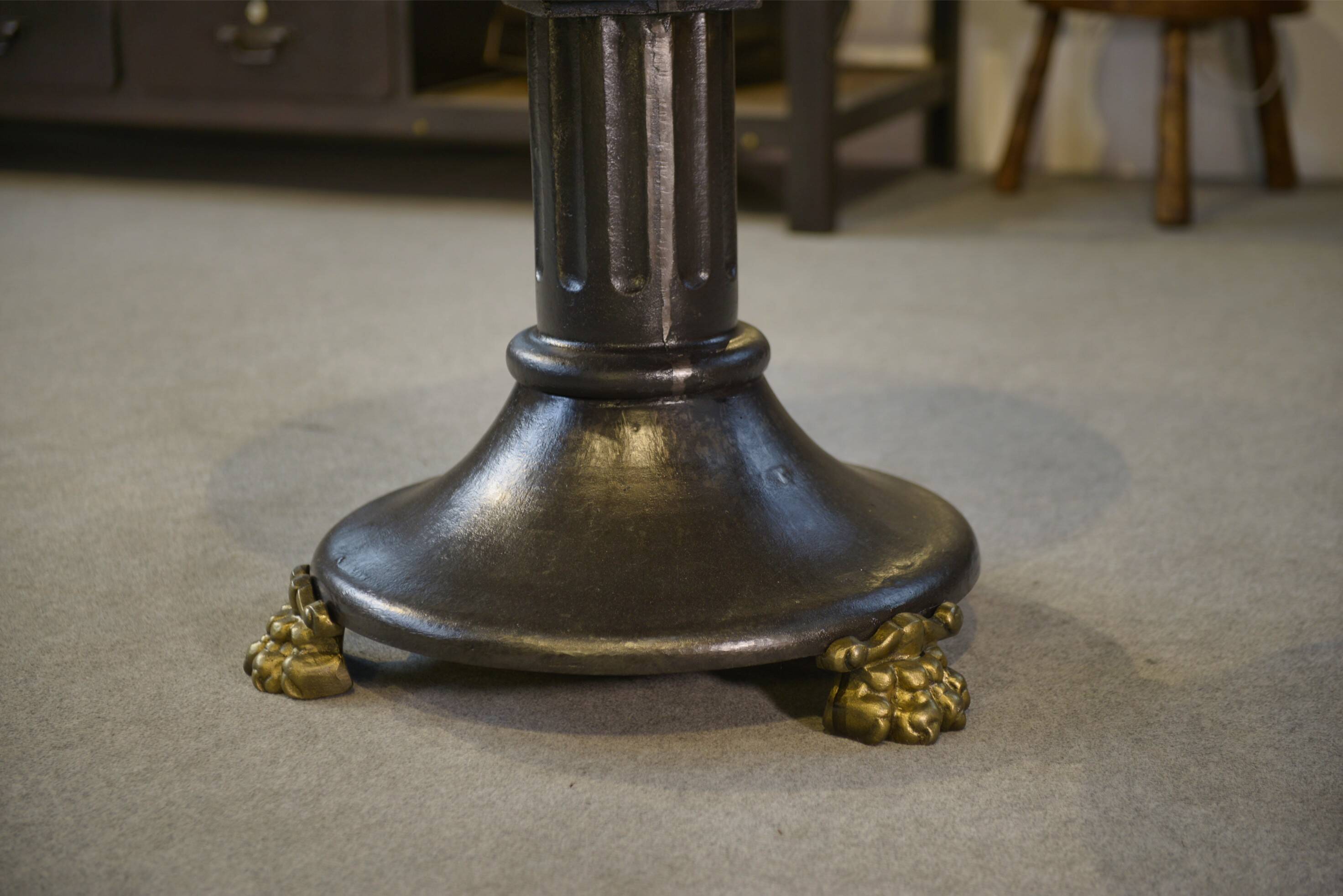 Neo-classical cast iron and glass eglomisé coffee table from the 1940s.