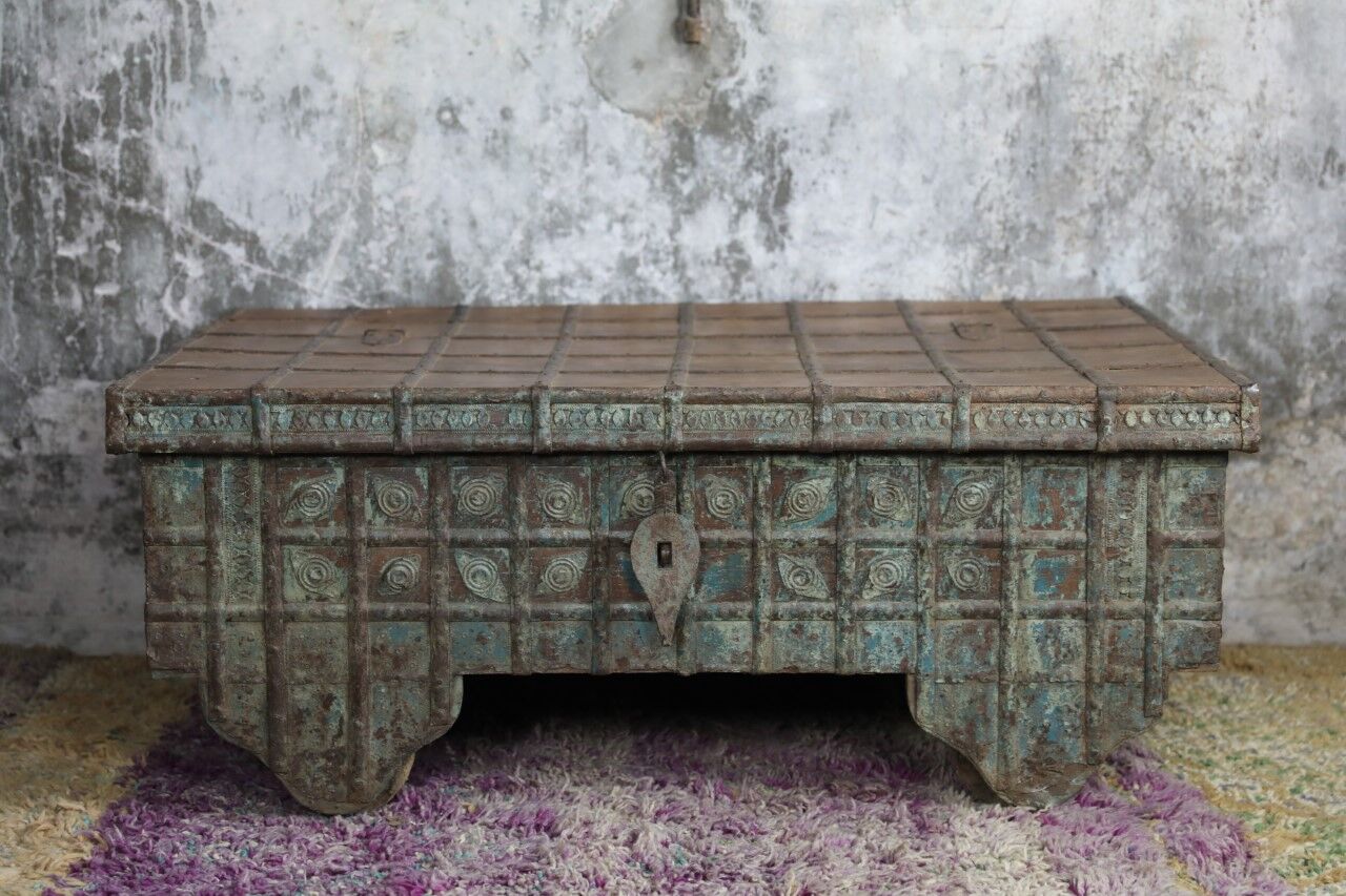 Low chest with metal closure and top opening.