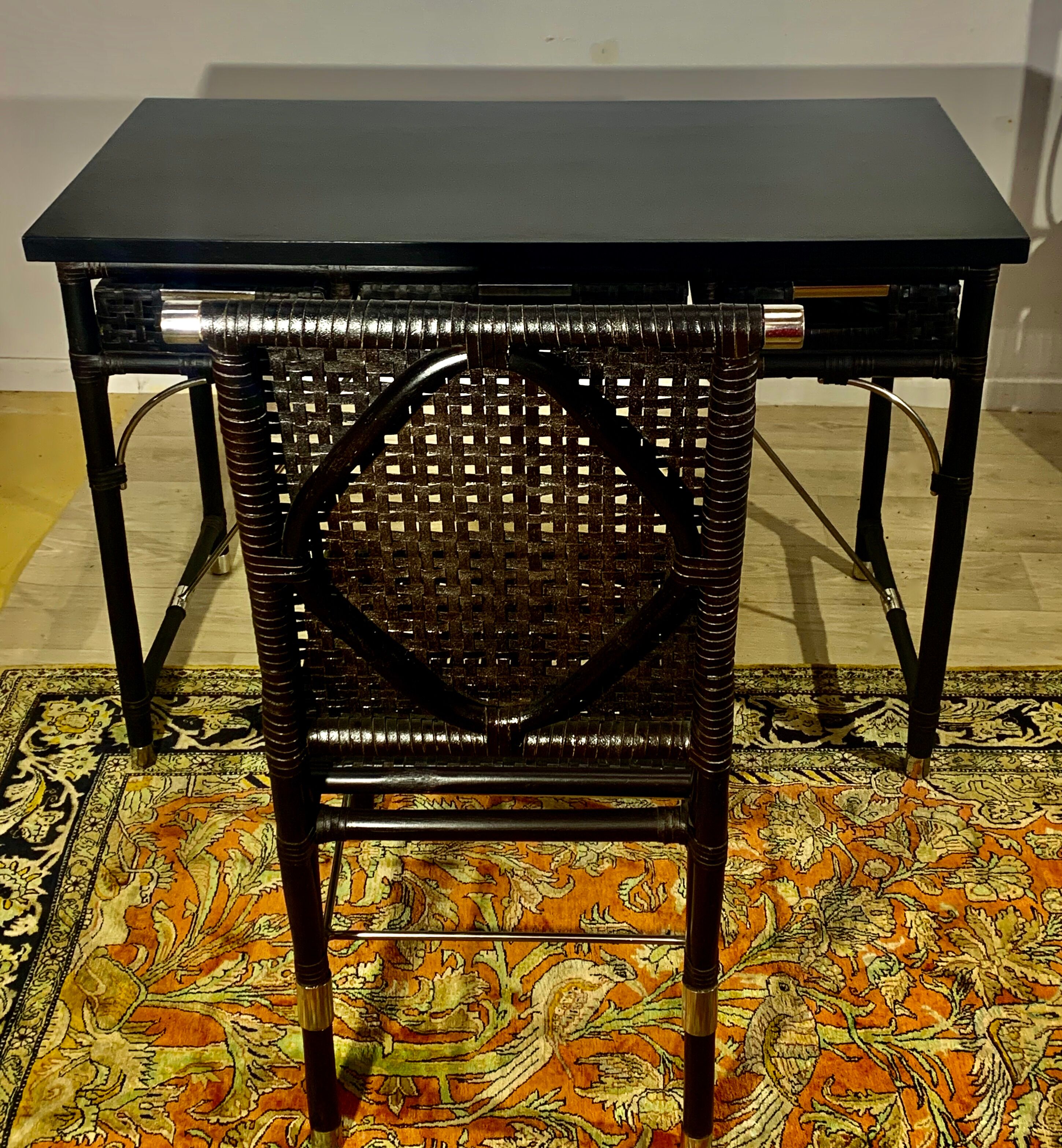 Office with its rattan armchair and brown leather braiding, italian design