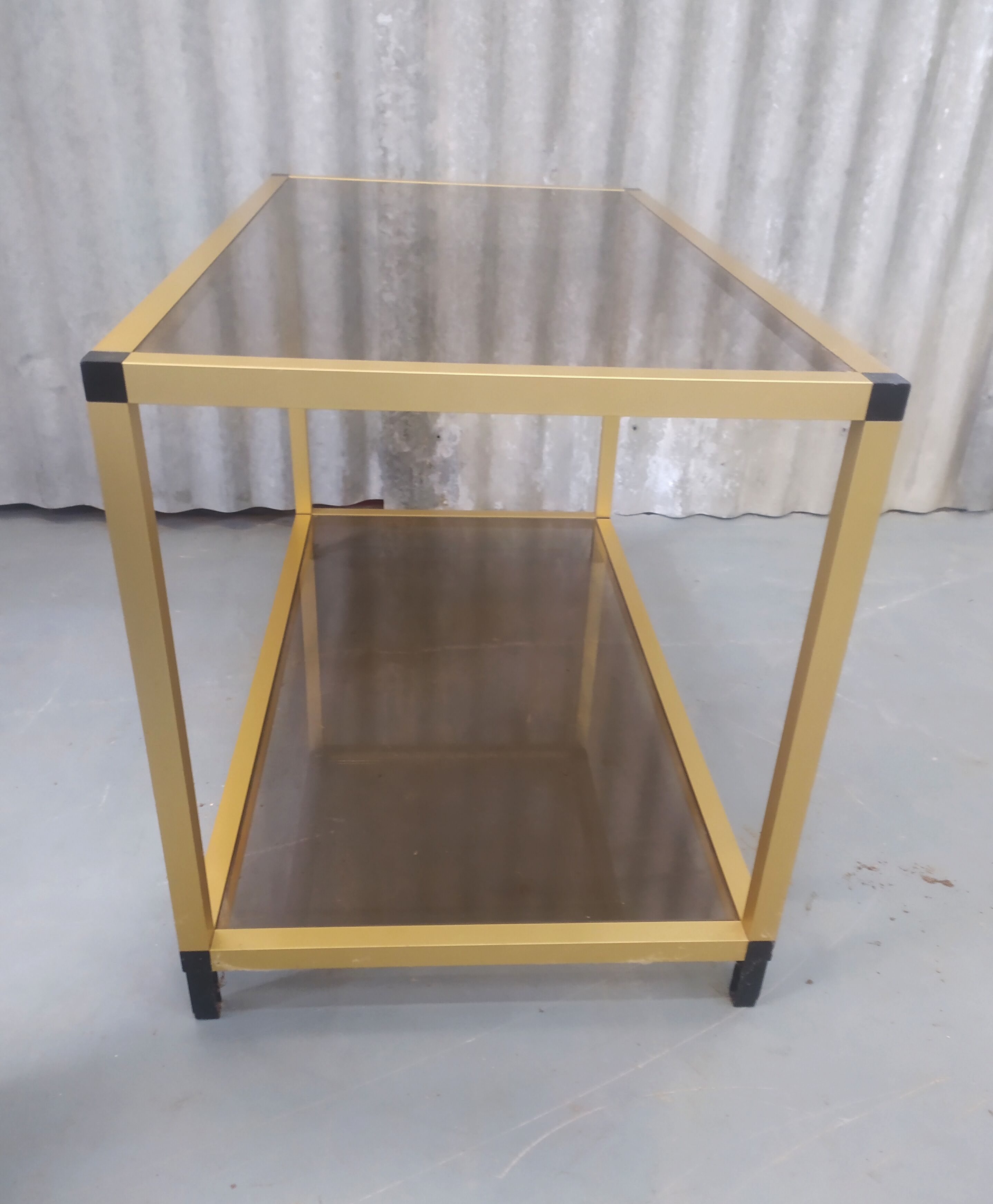 Gold metal coffee table and smoked glass