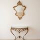 Golden wrought iron console and mirror in rococo style.