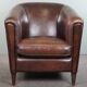 Fauteuil club en cuir de mouton foncé, design épuré