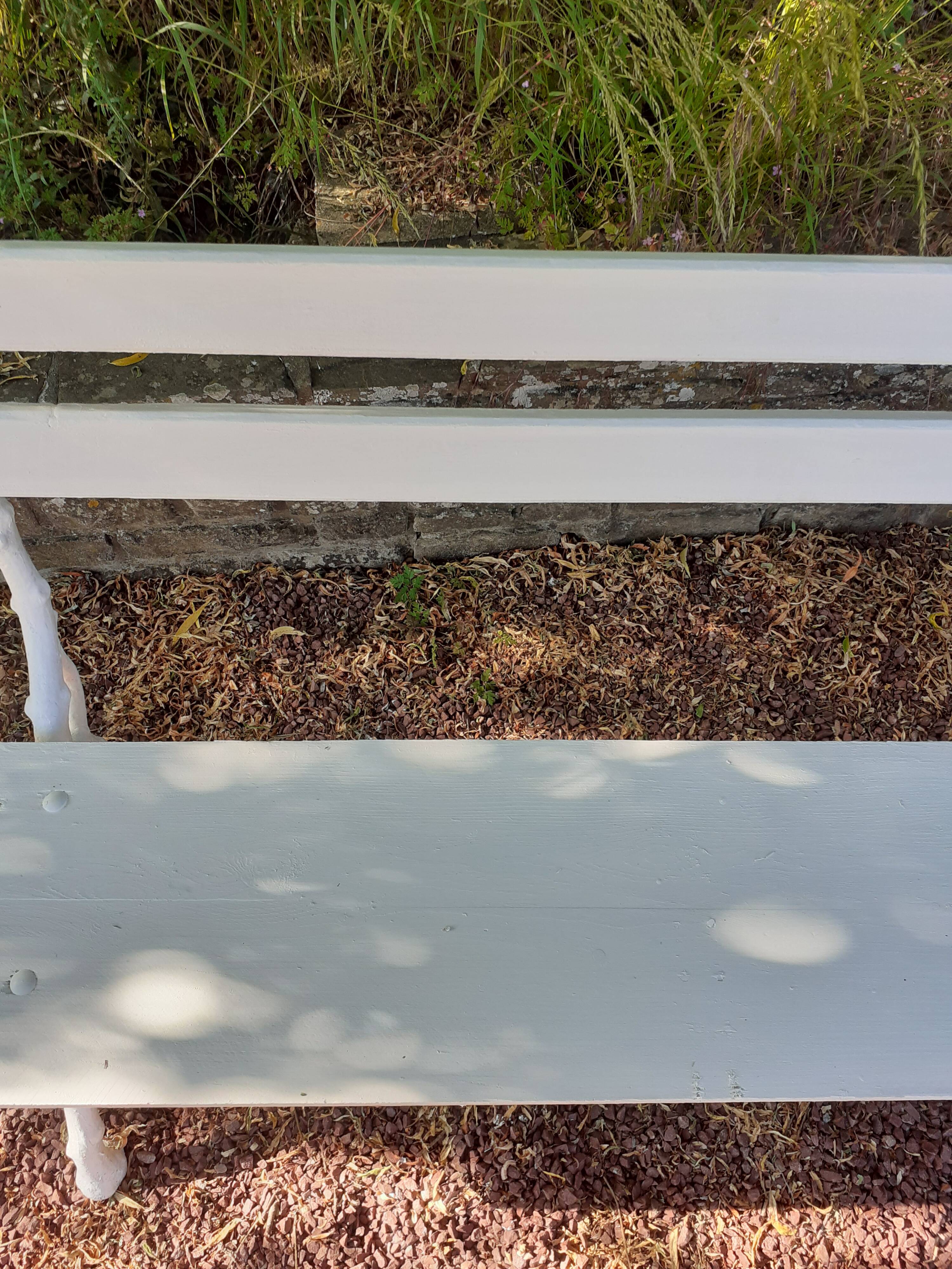 Old garden bench with cast iron feet and wooden planks