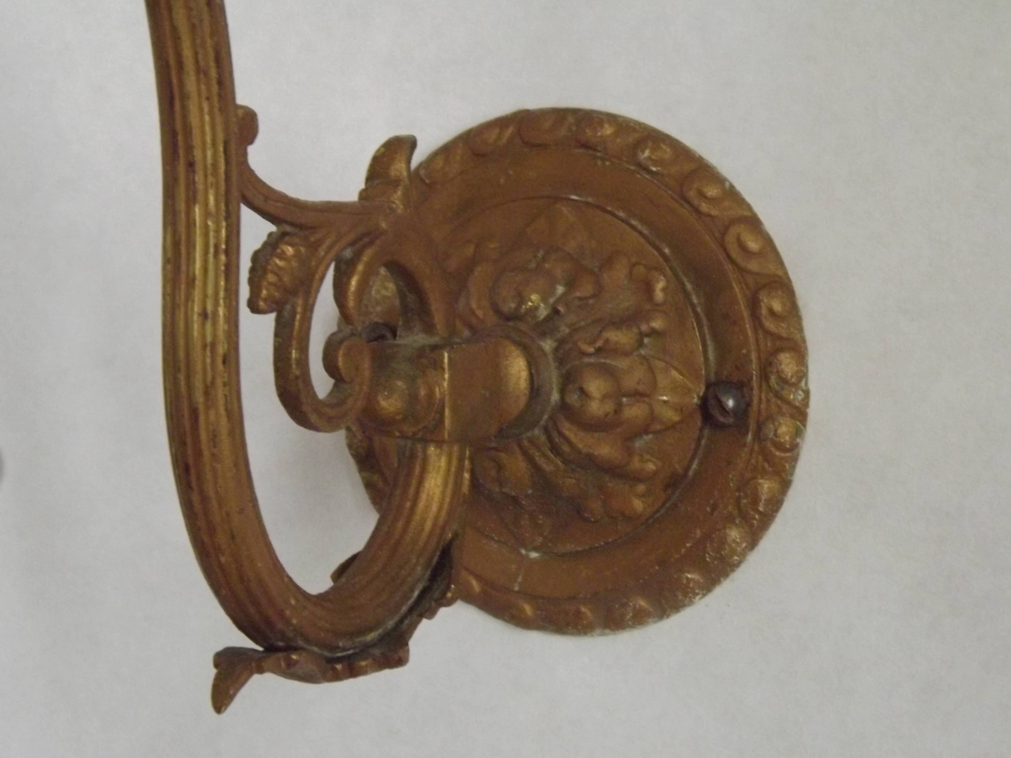 French Art Nouveau wall sconce in bronze with a white and pink glass shade.