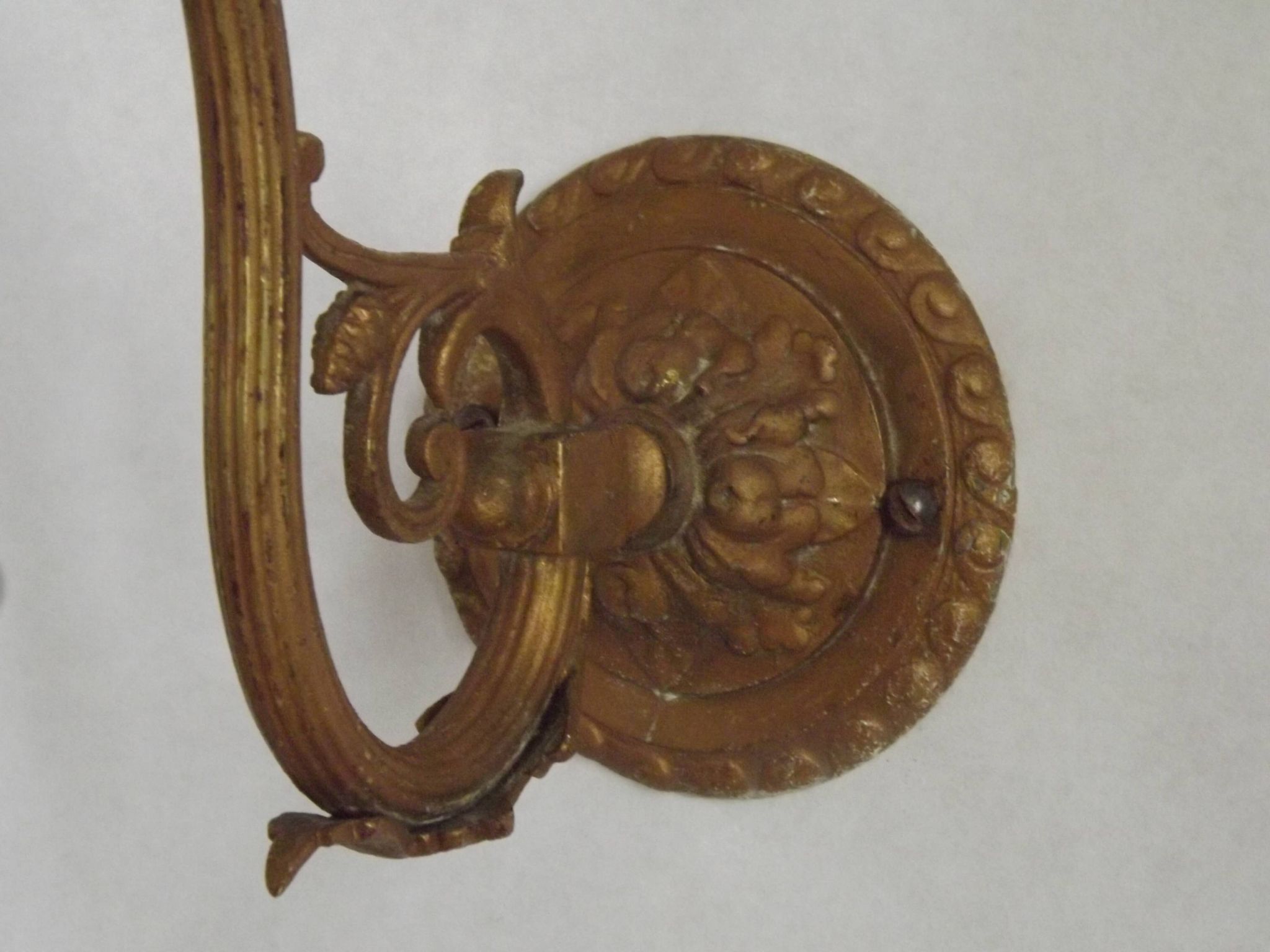 French Art Nouveau wall sconce in bronze with a white and pink glass shade.