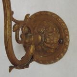 French Art Nouveau wall sconce in bronze with a white and pink glass shade.