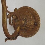 French Art Nouveau wall sconce in bronze with a white and pink glass shade.