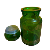 Green apothecary jar with golden patterns