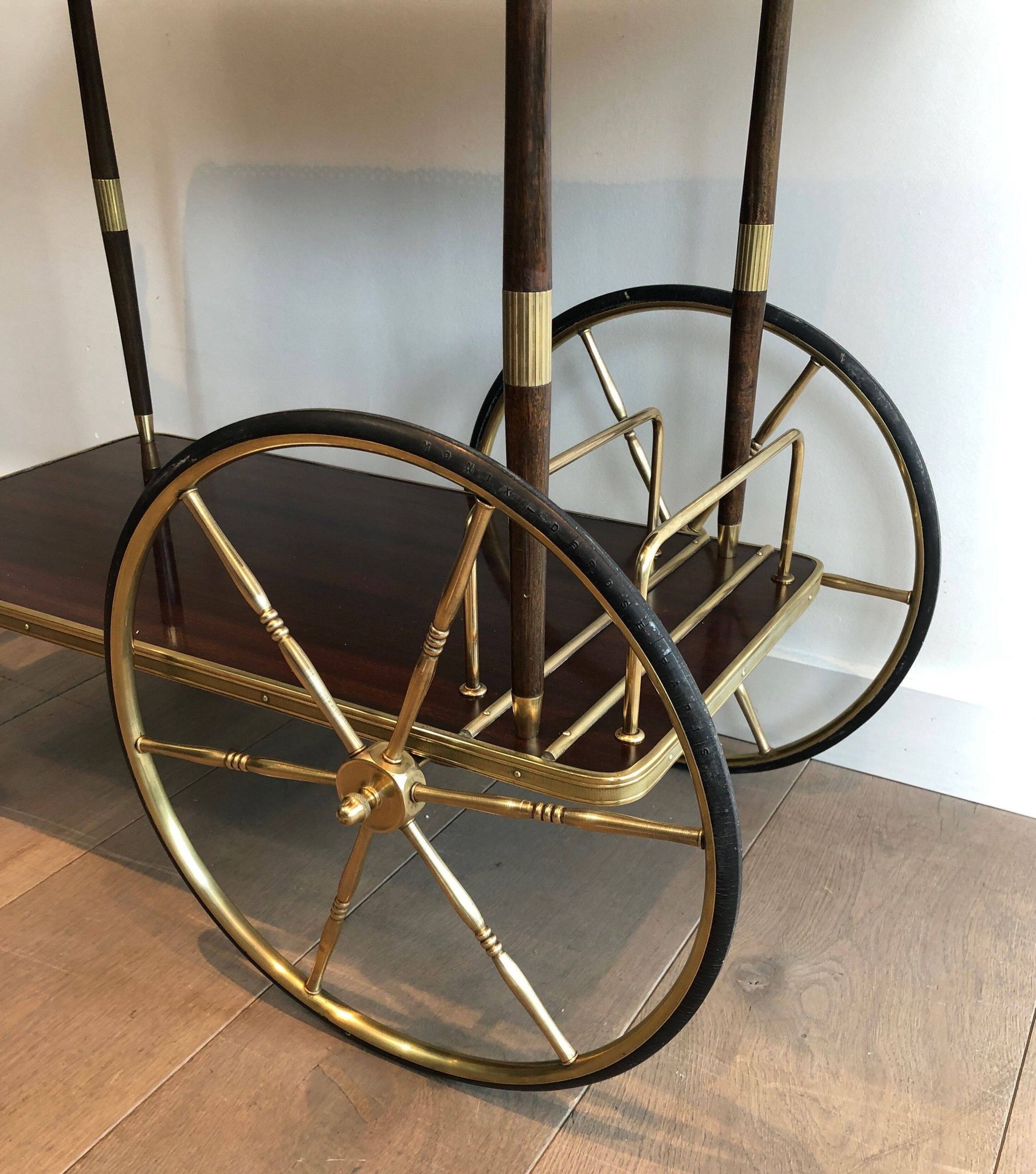 Mahogany and brass rolling table in the style of Maison Jansen.
