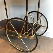 Mahogany and brass rolling table in the style of Maison Jansen.