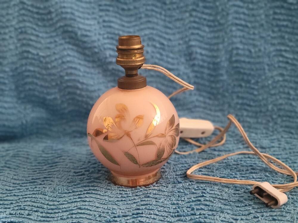 Antique lamp base with globe from the early 20th century.
