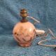 Antique lamp base with globe from the early 20th century.