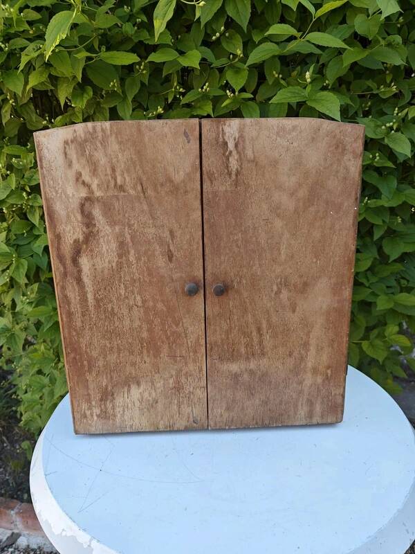 Small freestanding or wall-mounted wooden cabinet.