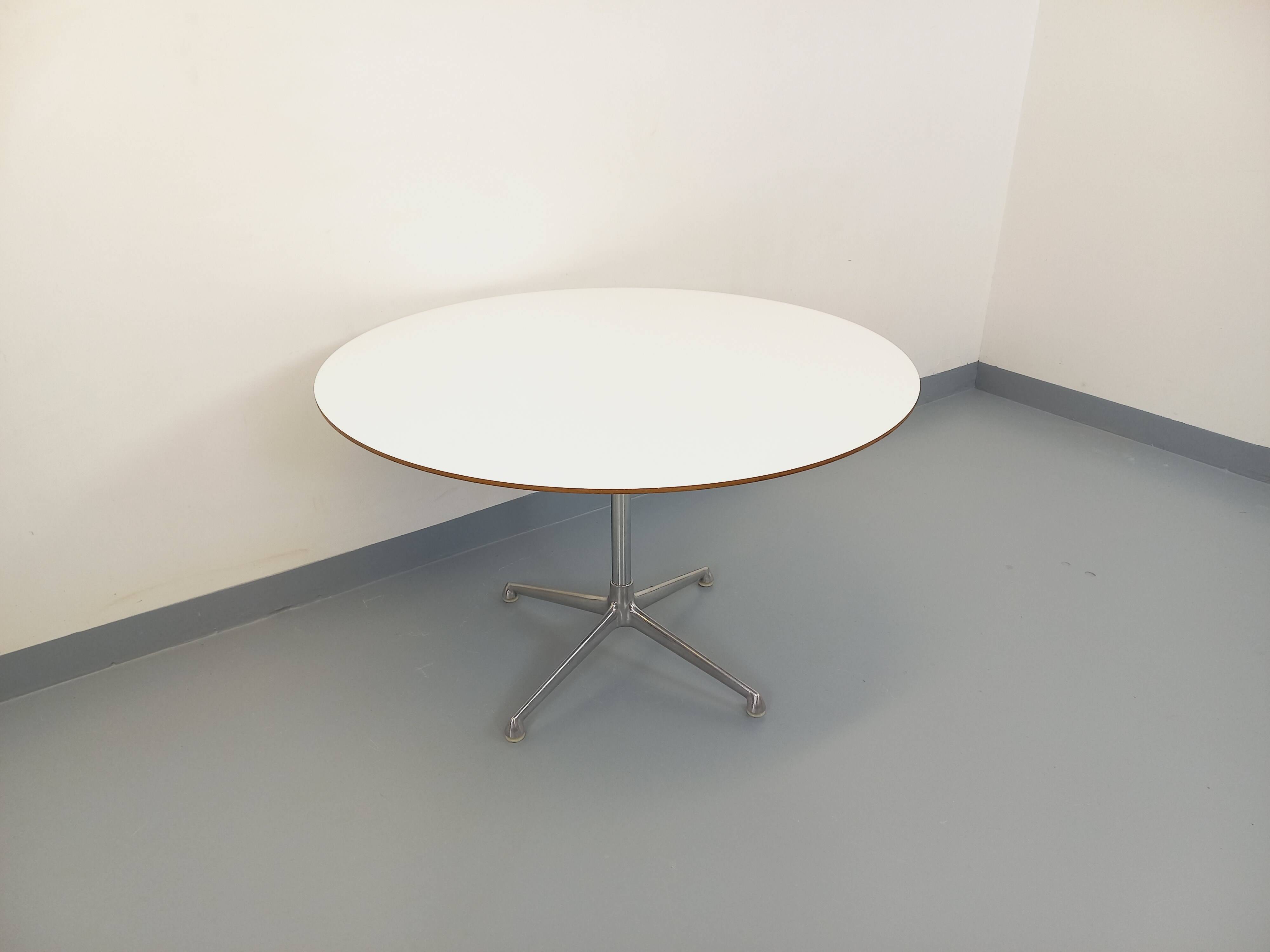 Vintage Eames round table for Vitra in white melamine, wood, and metal.