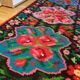 Colorful kilim on black background with floral design