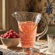 Antique glass pitcher with wheel engraving and floral decoration, Bohemia, early 20th century.