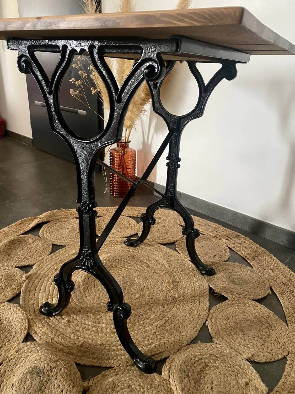 Bistro table with iron legs and raw wood top.