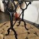 Bistro table with iron legs and raw wood top.