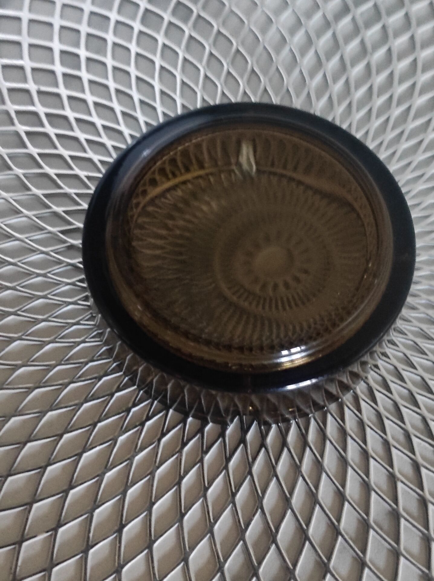 Dark smoked glass ashtray from the 1970s.
