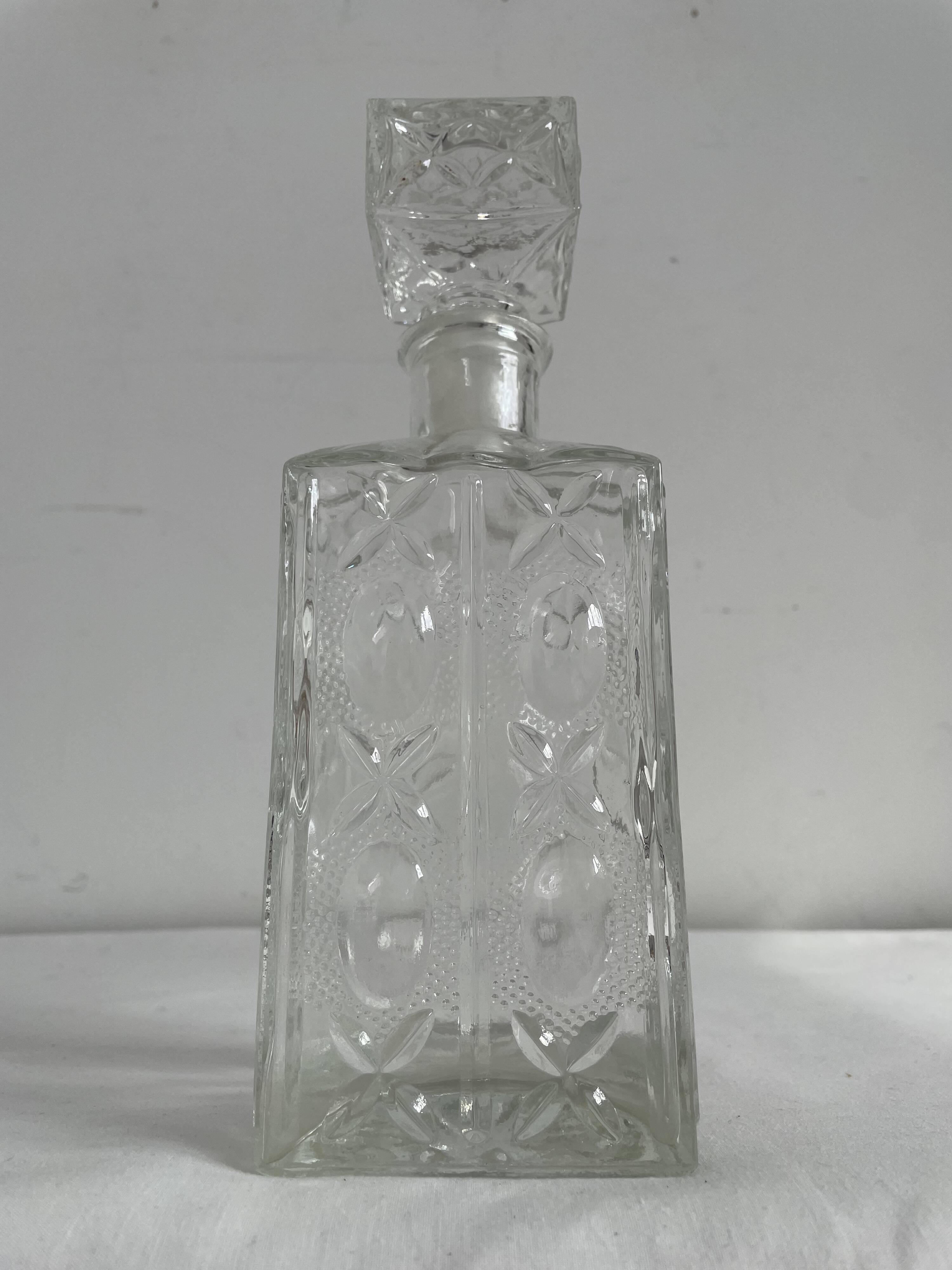 Molded glass carafe, 1960s-1970s, stylized flower decoration, oval, square base, stopper, rosette