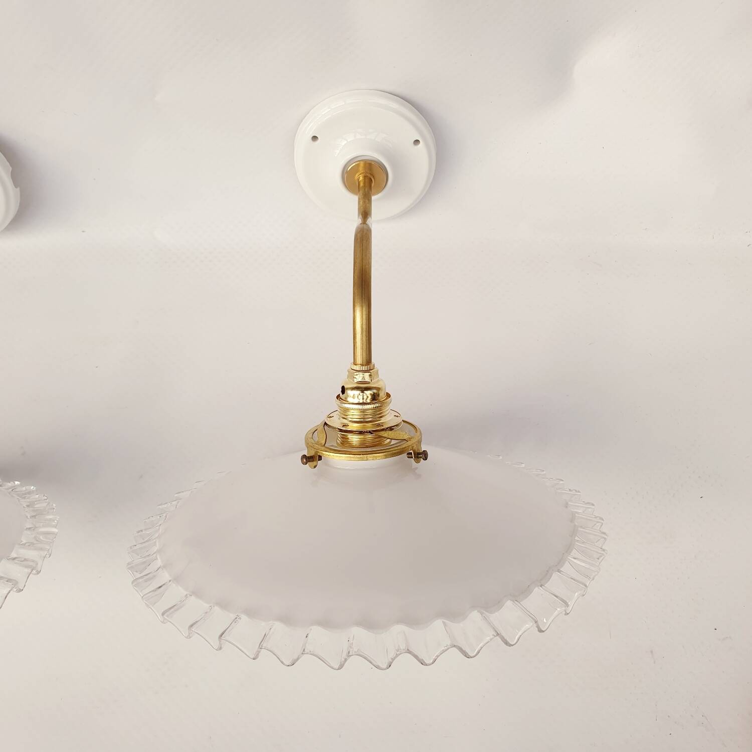 Swan neck sconces in serrated opaline