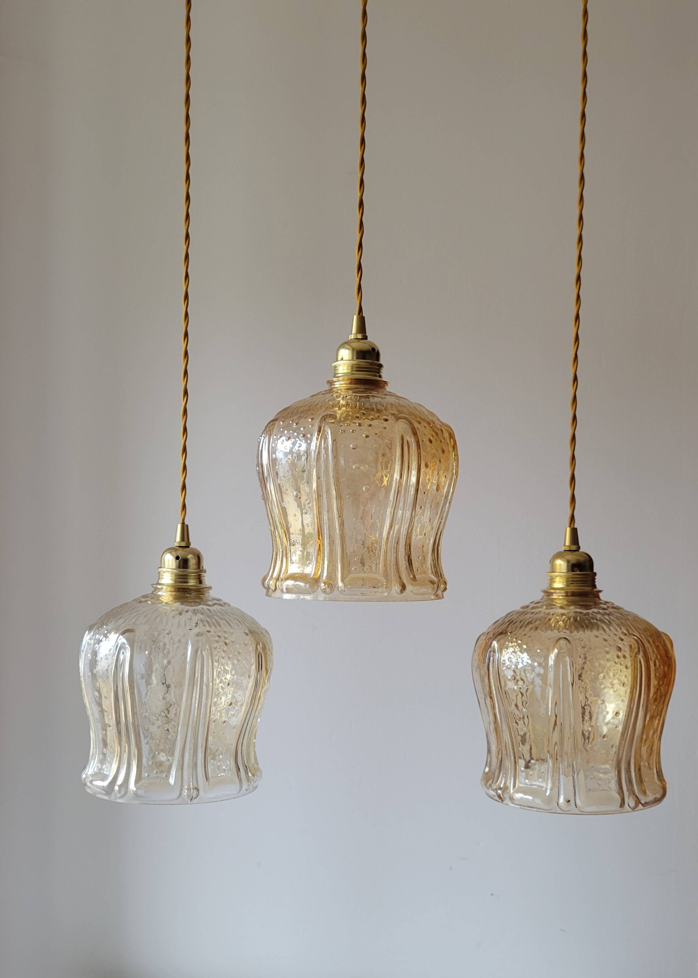 Trio of amber glass pendant lights