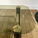 coffee table in smoked glass and black and gold metal from the 70s