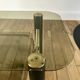 coffee table in smoked glass and black and gold metal from the 70s