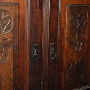 Hungarian wardrobe in carved brown wood from the late 19th century, with 2 doors and a lower drawer.