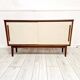 Mid-century teak sideboard with white synthetic doors.