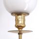 Three brass and opaque glass wall lights, 1950s.