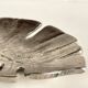 Leaf-shaped metal pocket emptier