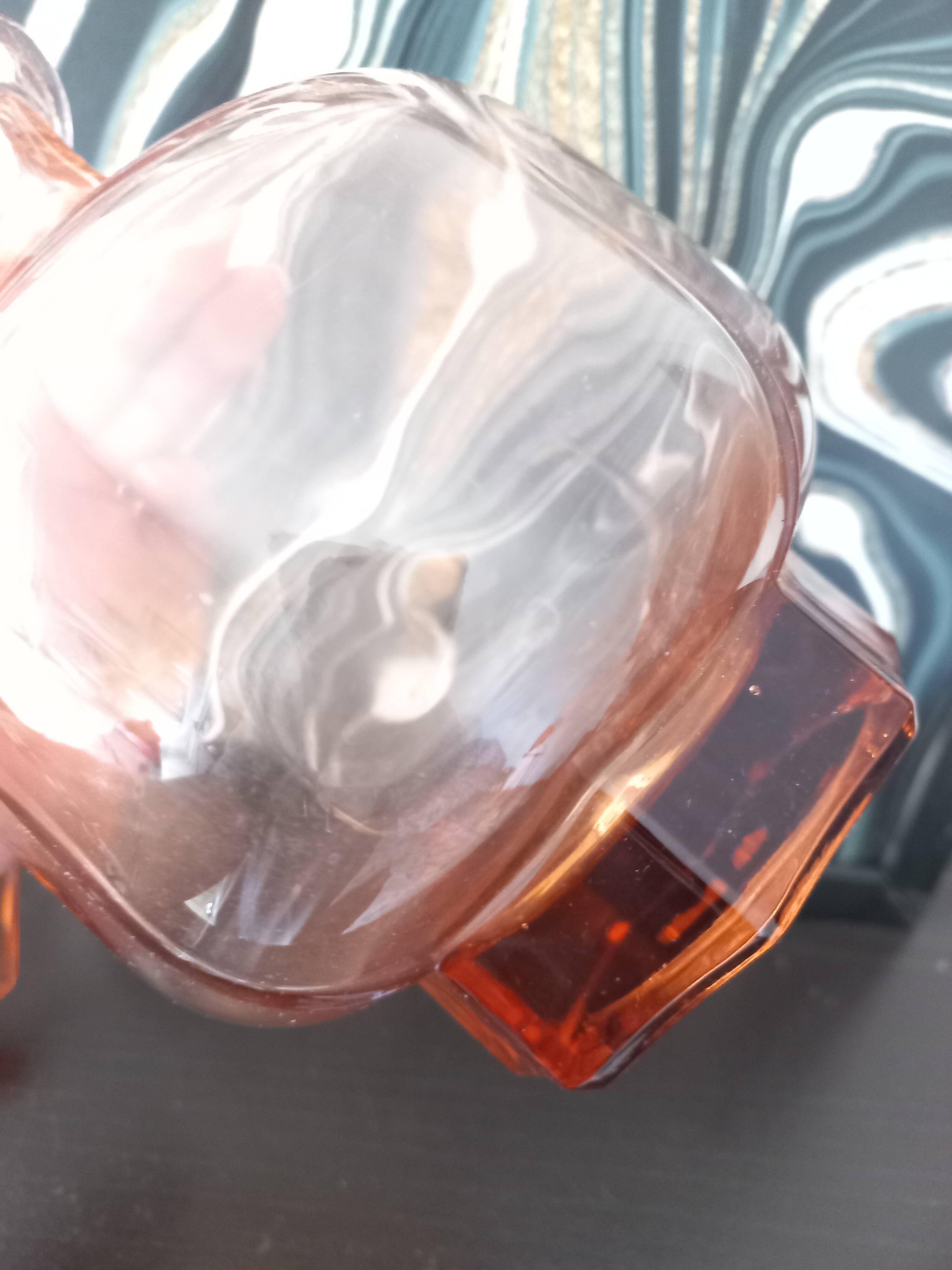Vintage glass carafe in pink-orange, retro-chic style.