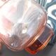 Vintage glass carafe in pink-orange, retro-chic style.