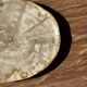 Small oval beige petrified wood dish or tray with speckled edges.
