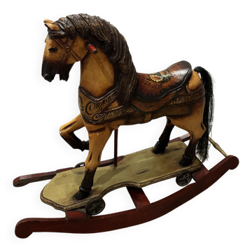 Antique hand-carved rocking horse on wheels, early 20th century