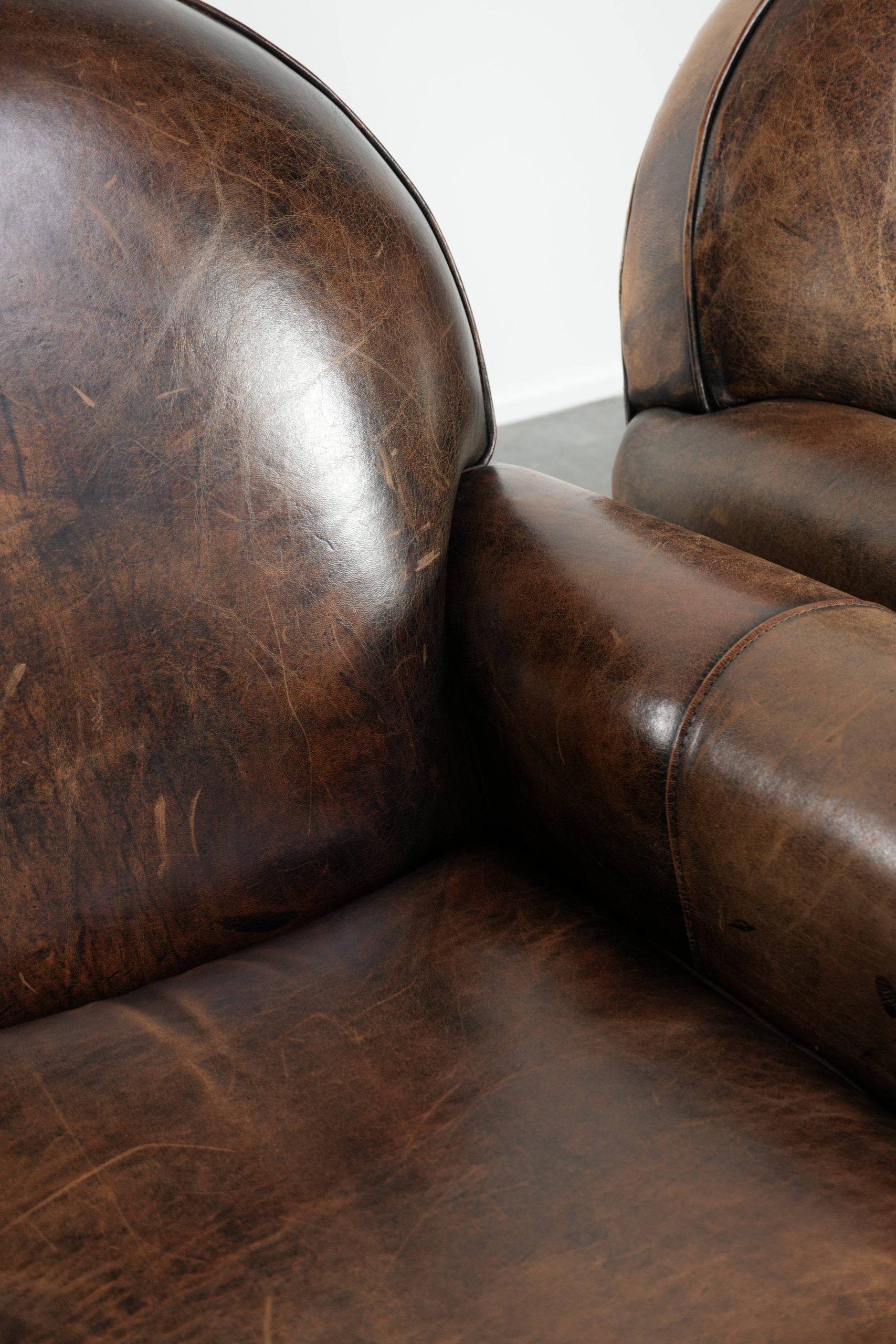 Set of two sheepskin Art Deco design armchairs with beautiful patina