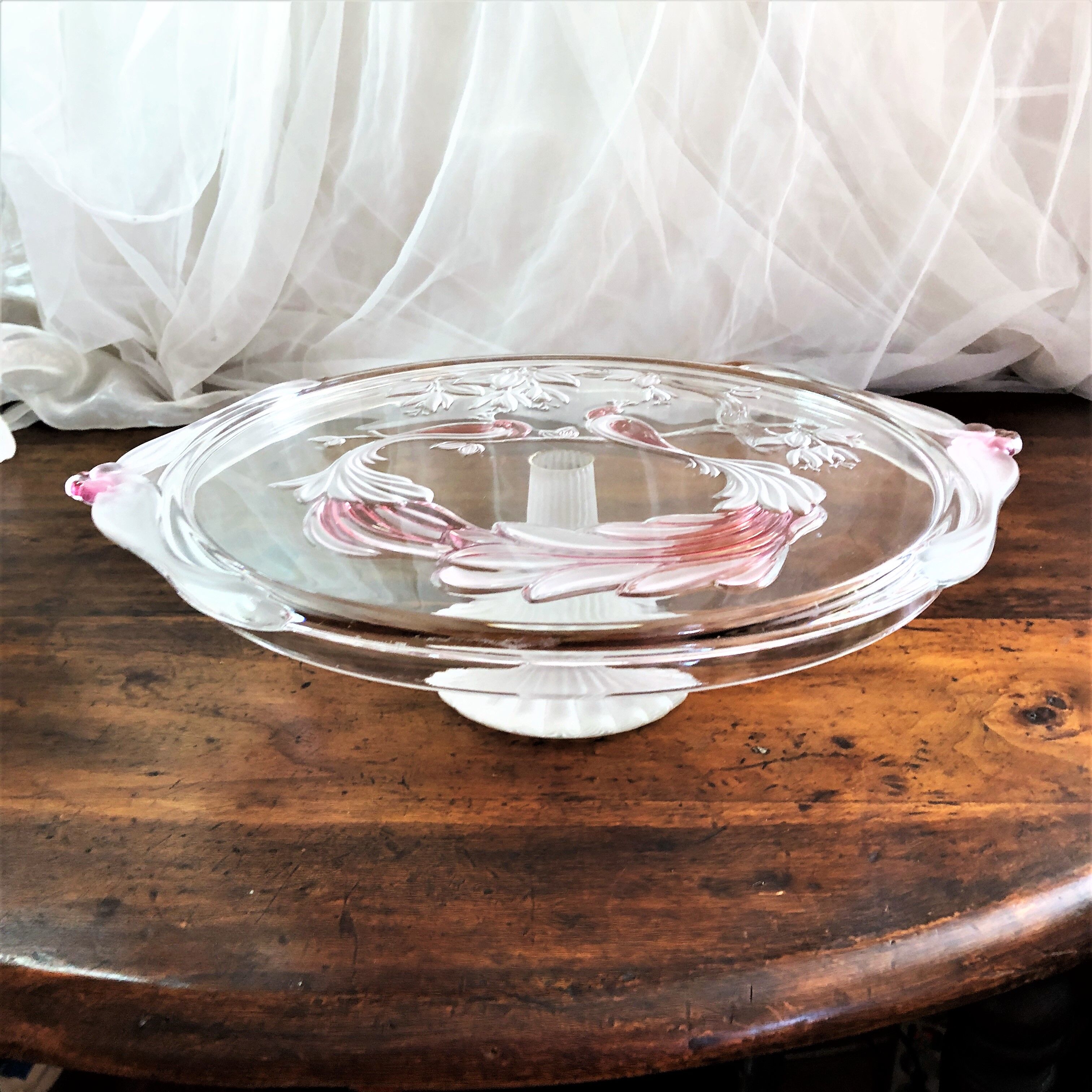 Large pie dish cakes on pedestal decorated with peacocks