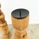 Pair of turned wooden candlesticks, raw and waxed.