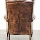 Vintage sheepskin wingback armchair in a deep brown colour finished