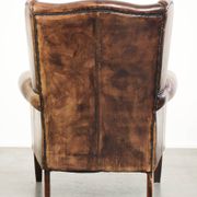 Vintage sheepskin wingback armchair in a deep brown colour finished