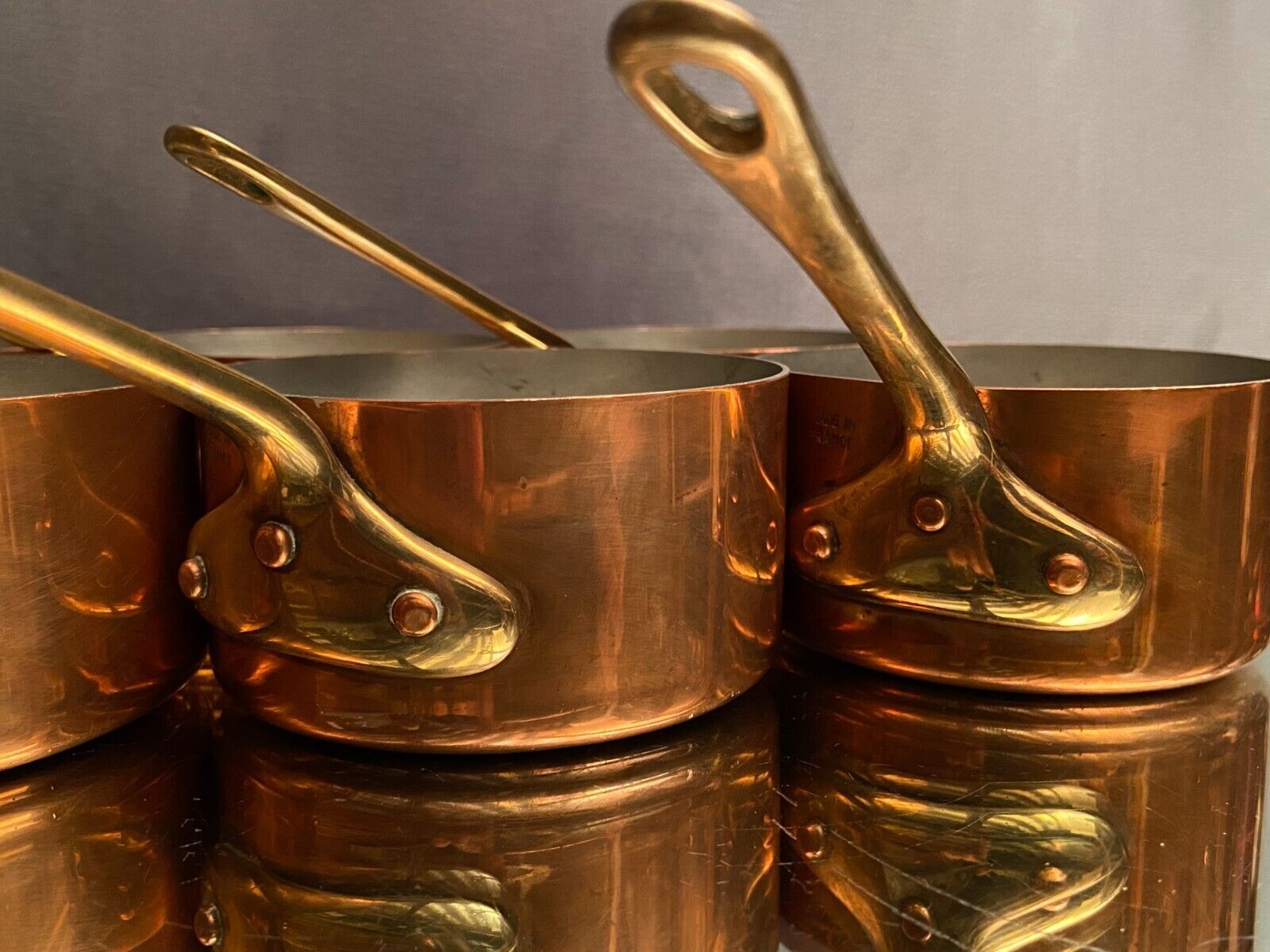 Suite of 12 tinned copper pans