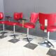 Quatre chaises de barbier en cuir rouge des années 1960 avec accoudoirs bakelite