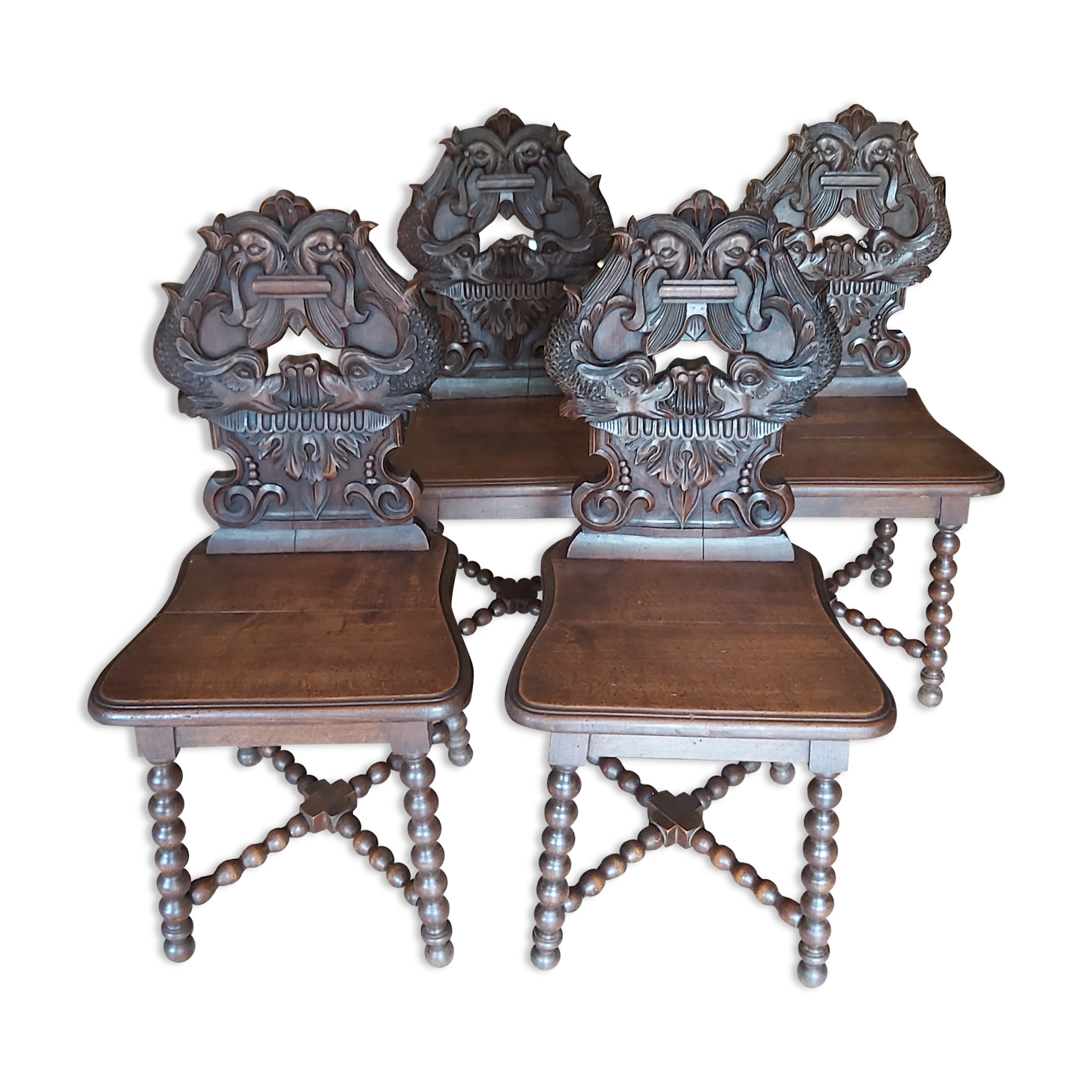 4 stylized dolphin back chairs