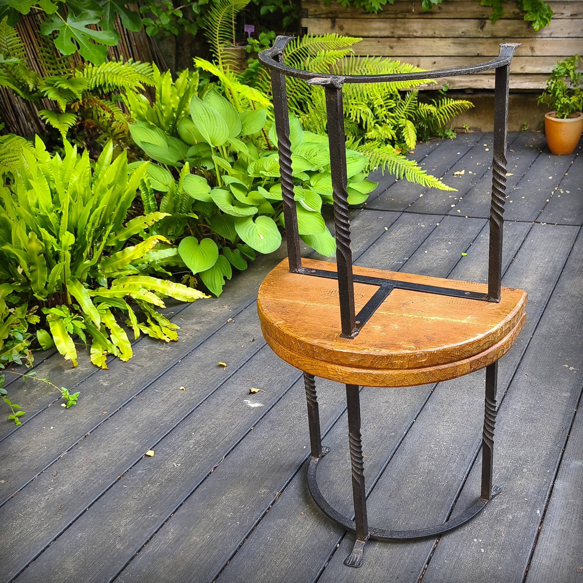 Pair of wrought iron and oak side tables, France, 1930.