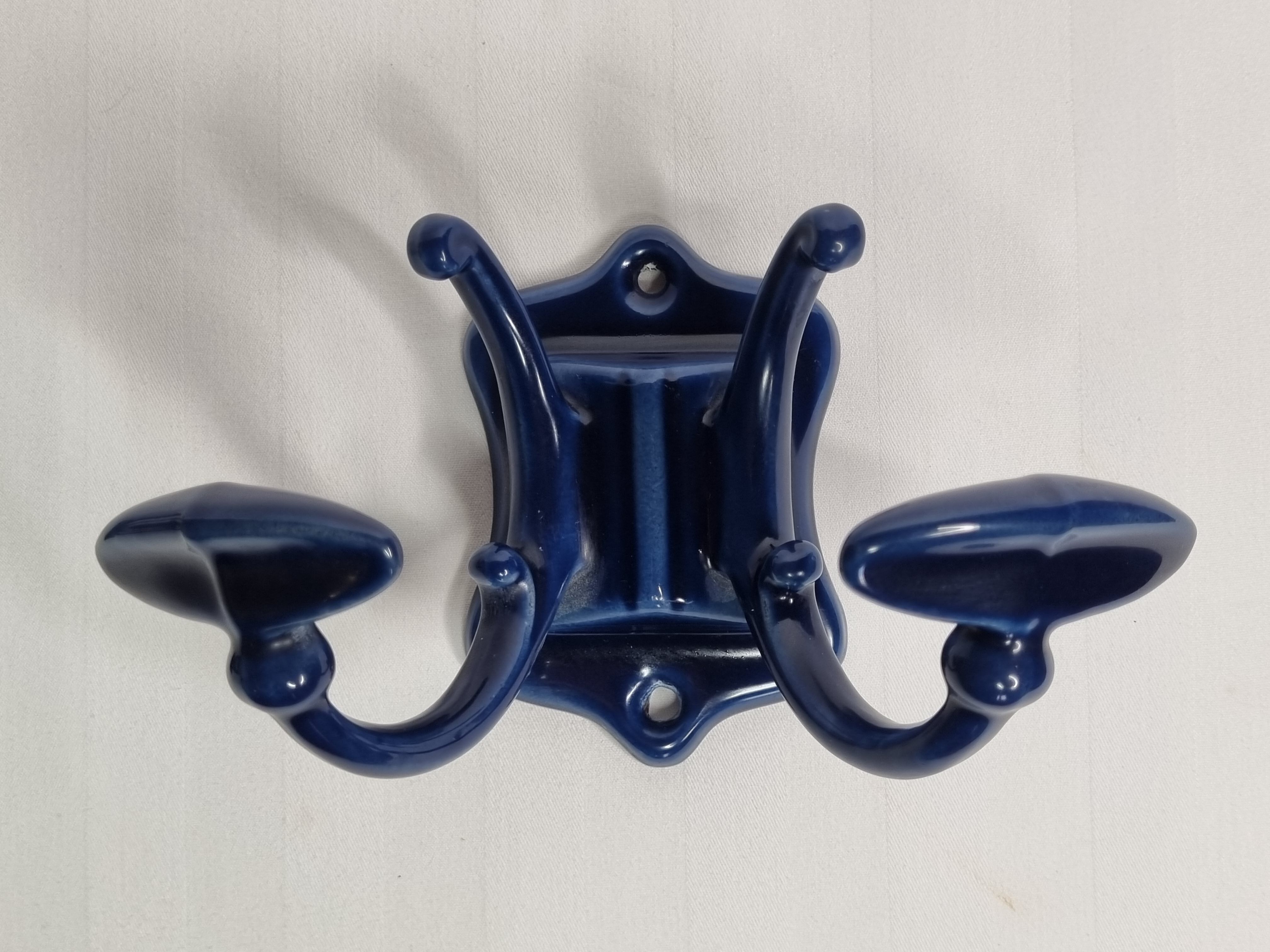 Pair of 1910 art nouveau period coat hooks in blue enameled cast iron