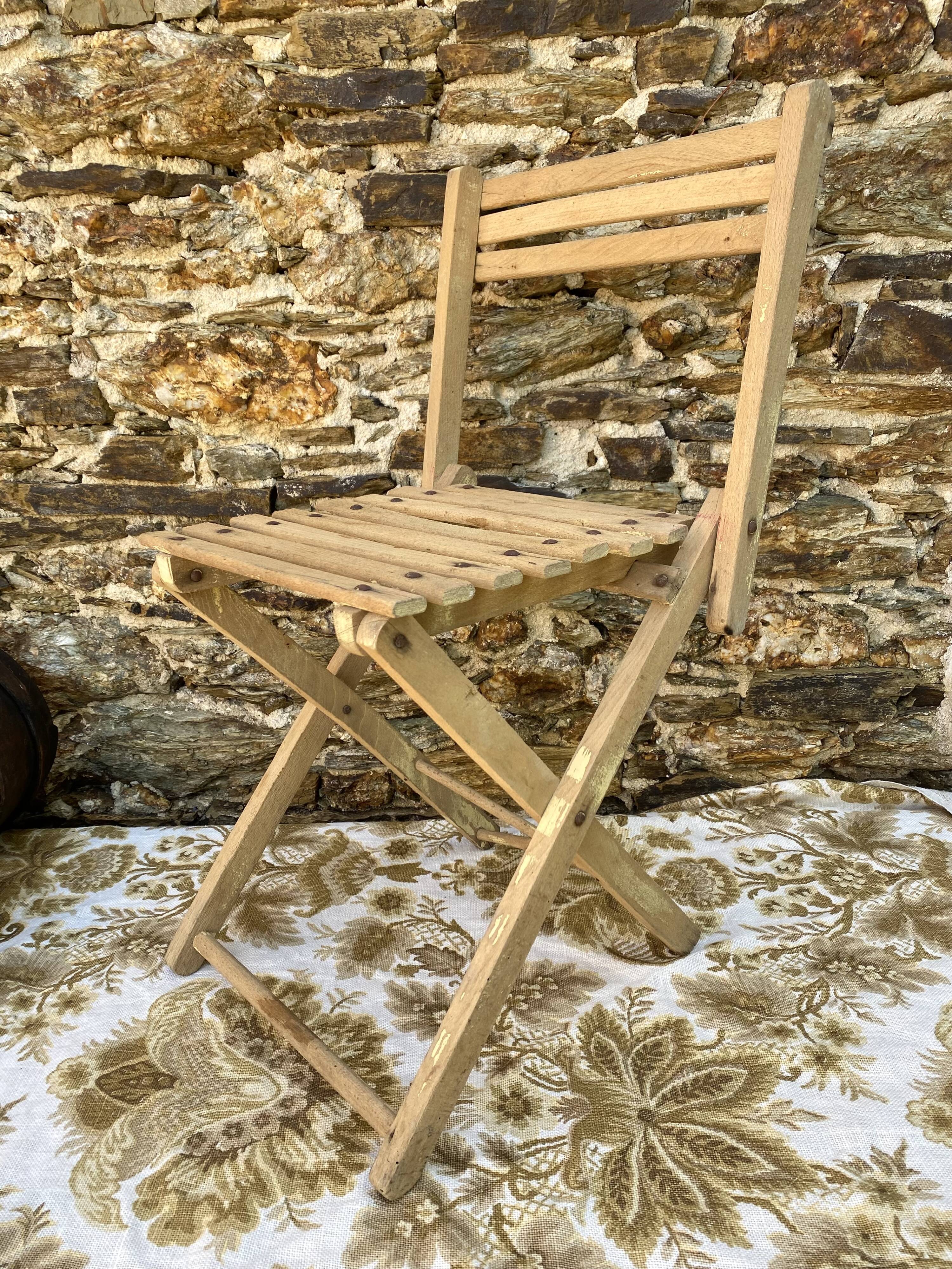 Antique folding chair with wooden slats