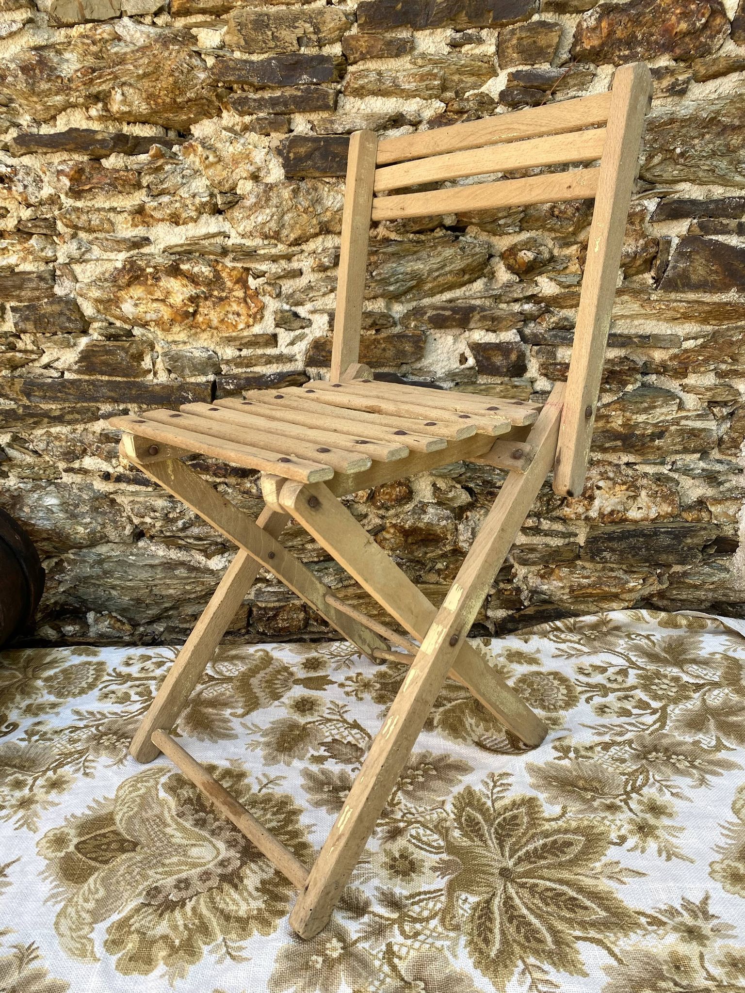 Antique folding chair with wooden slats