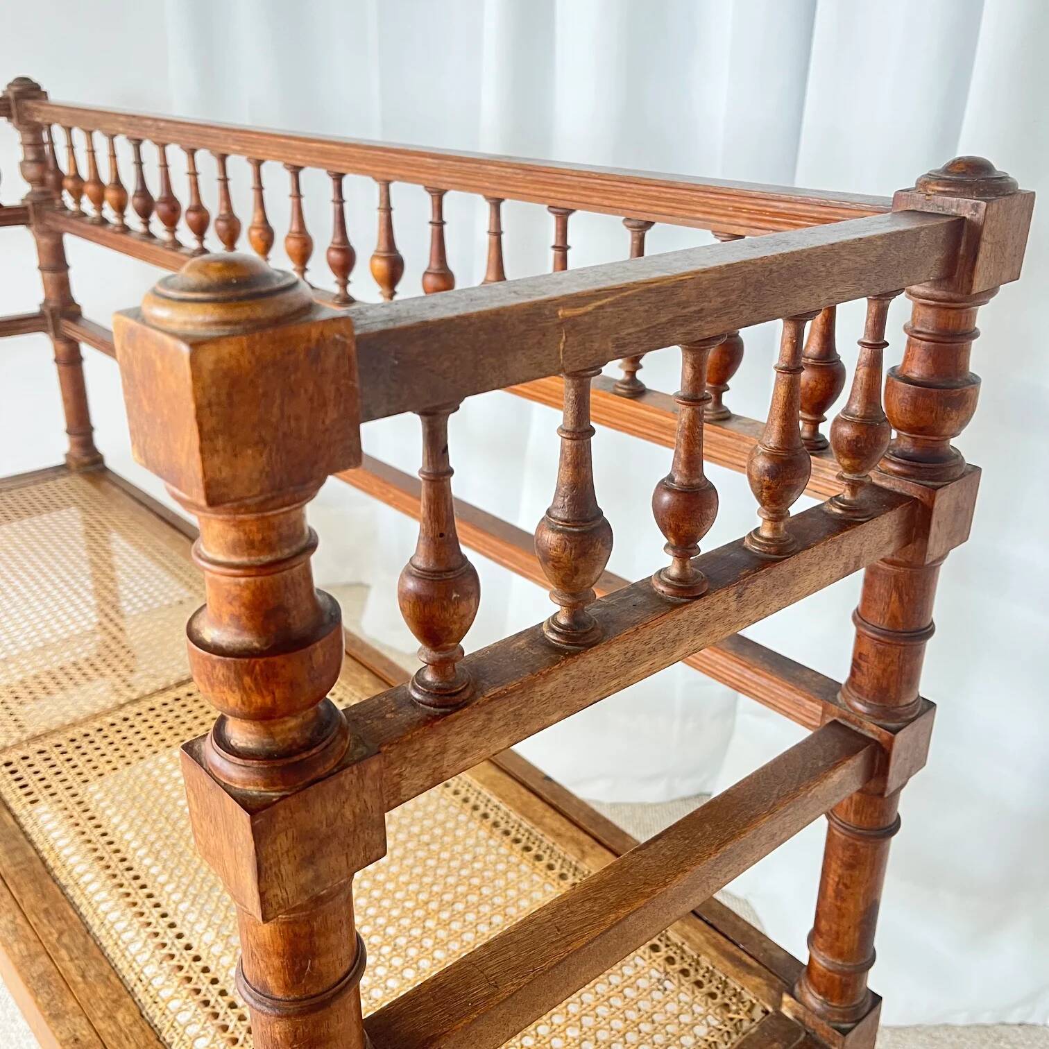 Antique banquette in Louis XIII style, turned wood with caning, late 19th to early 20th century.