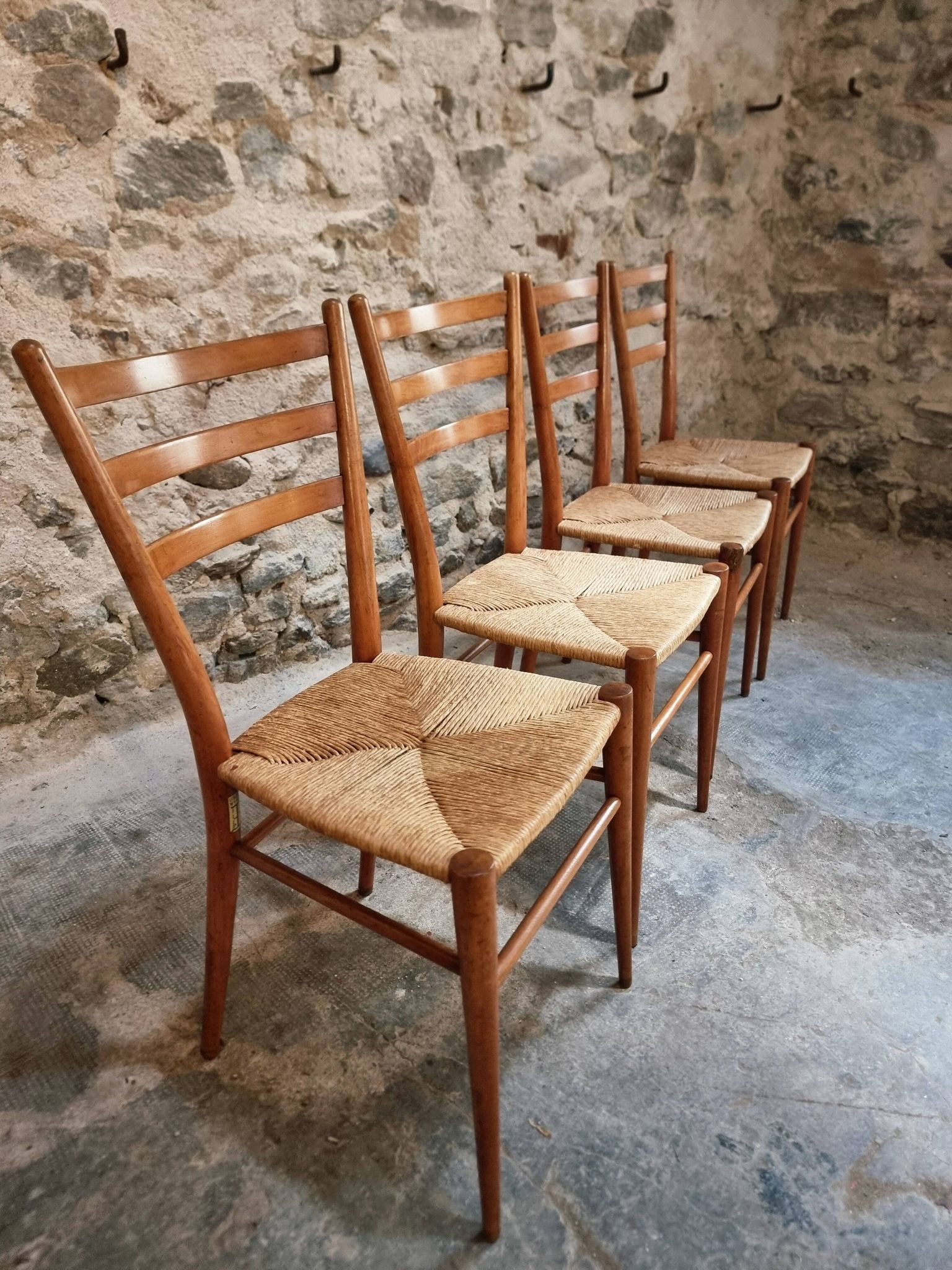 Set of 4 mid-century Italian dining chairs with woven seats, circa 1950–1970.